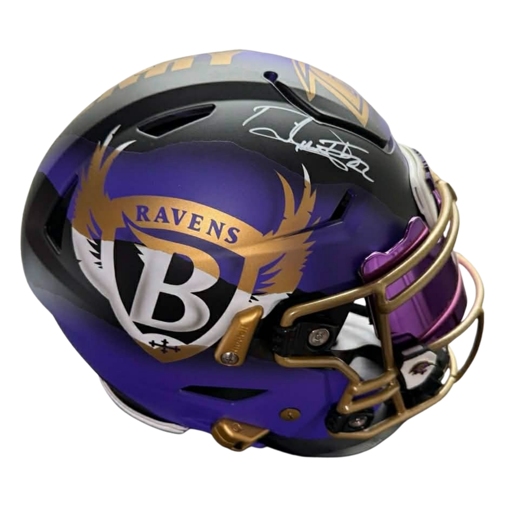 Ravens football helmet with gold and purple design on a white background