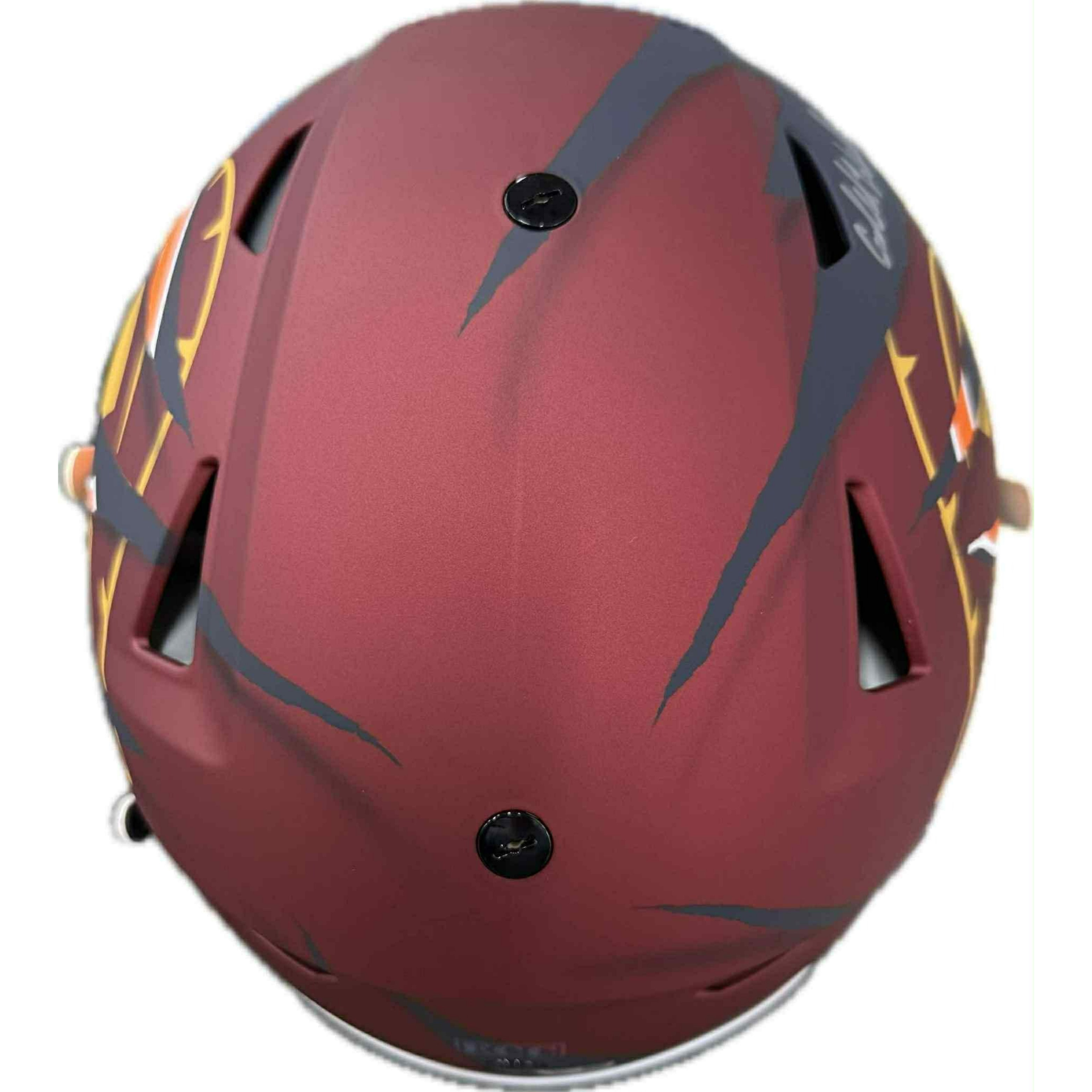 Maroon and black football helmet with USC-style Trojan design and multiple player signatures.